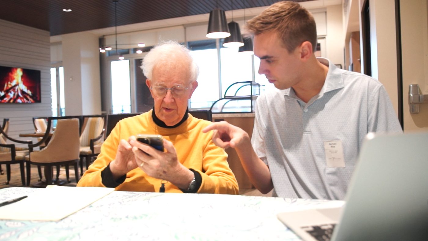Haven's founder working with local seniors on their devices